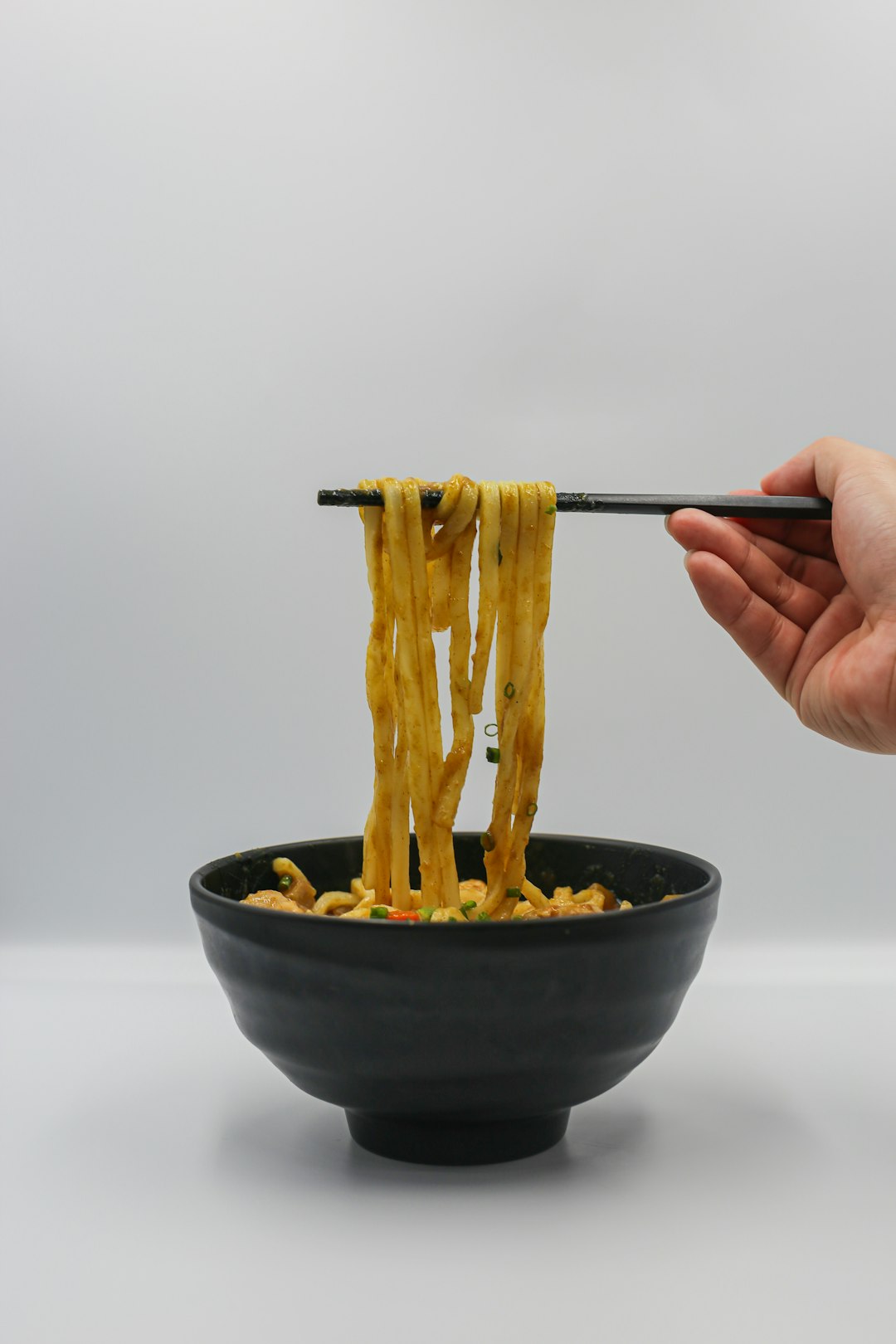 Cooking ramen noodles in a pot of boiling water